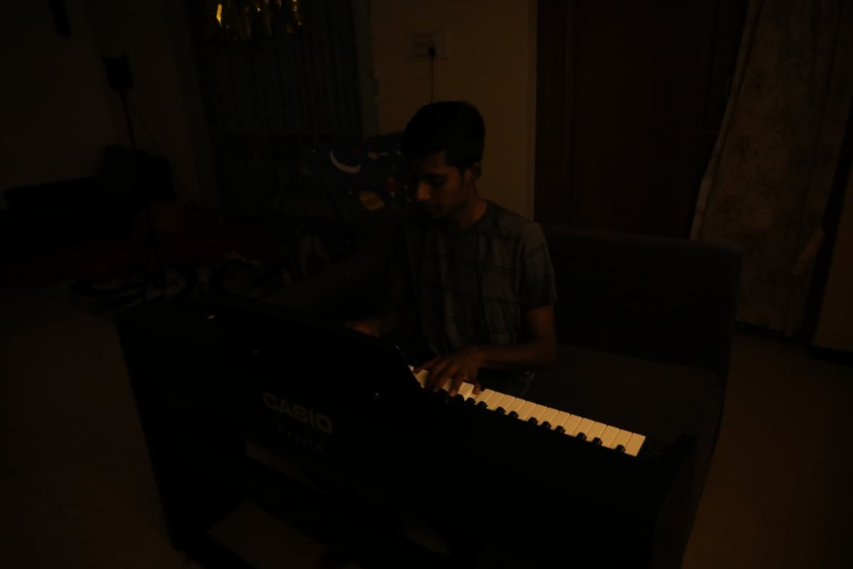 Young musician playing piano in an intimate setting